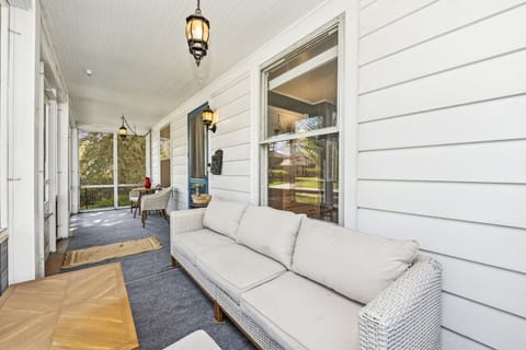 Inviting front porch with classic architectural details — perfect for morning coffee or sunset views.”