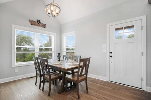 Dining area with natural light and rustic wooden table for six.