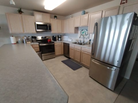 Well-stocked full kitchen with stainless steel appliances
