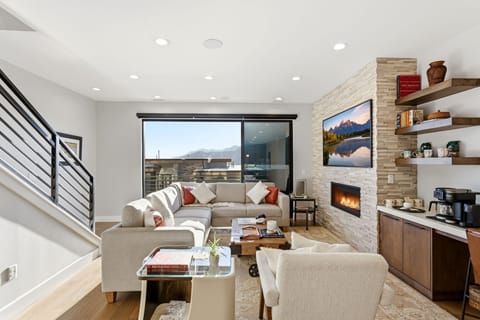 Bright living room with mountain views and fireplace