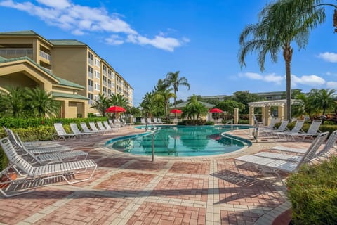 Relax by the sparkling resort pool with lounge chairs and shaded seating.
