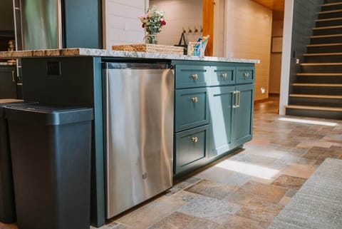The Main Cabin
The kitchen island is packed with thoughtful extras just for you! You'll find a beverage fridge, a drawer with coloring supplies for little ones (on the left), a neatly organized junk drawer, and plenty of extra storage throughout.