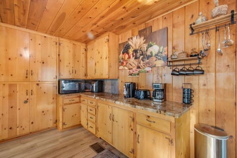 Kitchen with Keurig coffee maker and ample cabinet storage.