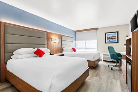 Unwind in bright double-queen comfort with crisp hotel linens.