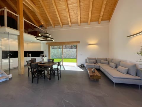 PEPPOLA - Open modern kitchen and living area with comfortable sofa