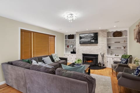 Spacious  and warm living room with fireplace — perfect for relaxing after a day outdoors.