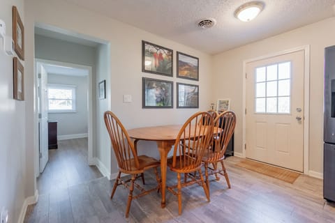 Enjoy meals or morning coffee in this bright, cozy dining nook with charming wall art and natural light.