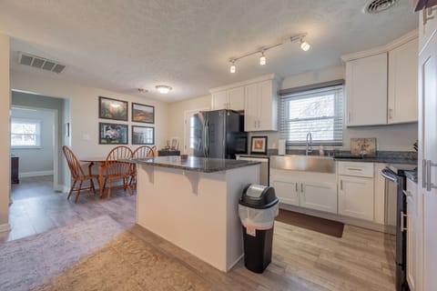 Cook, dine, and connect in this bright, open kitchen with granite island and cozy dining space.