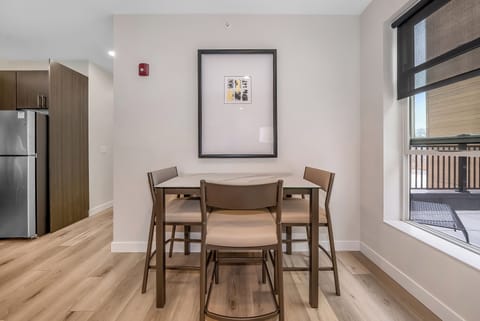 Gather around your stylish dining table for meals and conversations, with natural light streaming through the window.