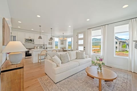 The great room at Hygge Ridge is bright and open with a fireplace and clean Nordic inspired designs