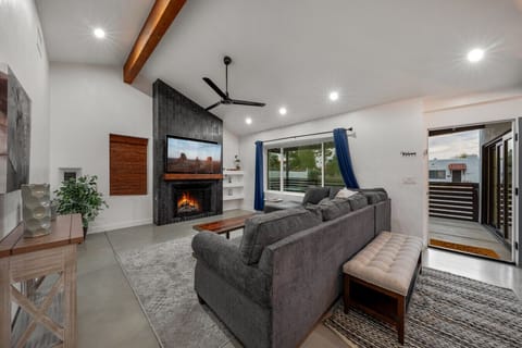 Living room with plenty of cozy seating, smart TV, and fireplace (not functional)