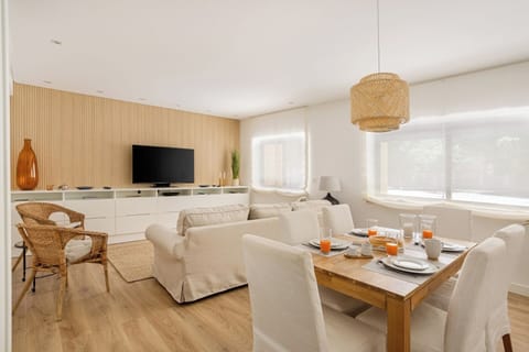 Living room with a comfortable seating area, TV, AC and Dining table for 6. 