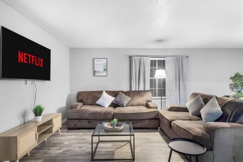 Spacious and inviting living area with comfortable seating and a smart TV, perfect for relaxing after exploring Arlington or attending events at AT&T Stadium.