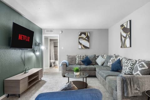Spacious and inviting living area with comfortable seating and a smart TV, perfect for relaxing after exploring Arlington or attending events at AT&T Stadium.