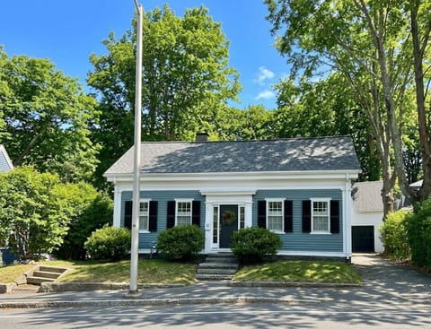Charming tree-lined cottage with classic curb appeal and sunny frontage