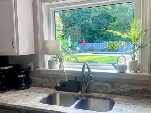 Large picture window and sliding glass door, provide a great view to the backyard and pool area.  