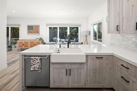 Cook with ease at the oversized island featuring bar seating, generous prep space, and clear views toward the yard.