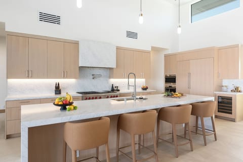 Your gourmet kitchen awaits with marble counters, premium appliances, and a spacious island perfect for cooking together.
