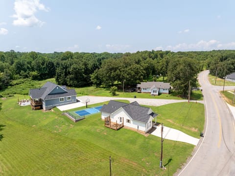 Welcome to our downtown Greer retreat with two beautifully appointed homes united by a private pickleball/ basketball court, offering an elevated escape for family and friends