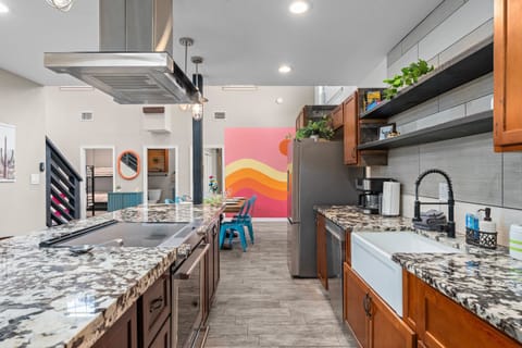 Wide-open kitchen flows straight into the fun: cook, chat, and keep an eye on the game room action all at once.