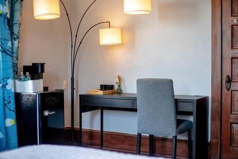 A dedicated work space with mini fridge and coffee maker.