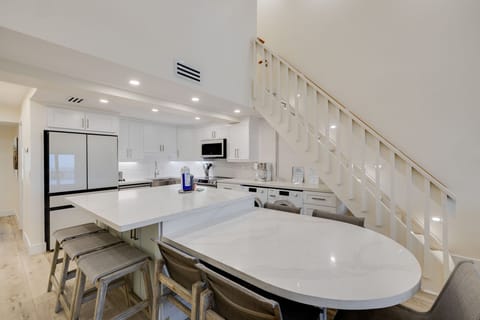 Gorgeous living room and kitchen with expansive island, new Samsung Bespoke appliances