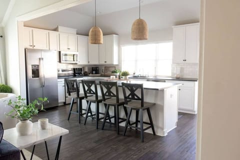 The fully equipped kitchen has everything you need for cooking and casual meals, with a stylish bar area perfect for gathering or enjoying a quick bite.