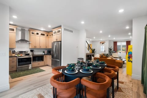 Dining Room: Highlights include contemporary designer seating, an open-concept layout to the kitchen, and abundant natural light. Enjoy a seamless flow between cooking and dining in this bright, stylish space.
