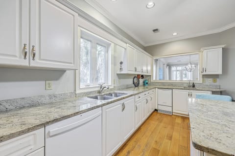 Cook with ease in this airy kitchen featuring modern appliances and ample granite counter space.