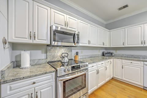 An open-concept kitchen and dining area designed for seamless island entertaining.