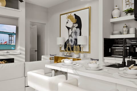 Sleek kitchen with breakfast bar seating, perfect for casual meals or morning coffee before the beach.