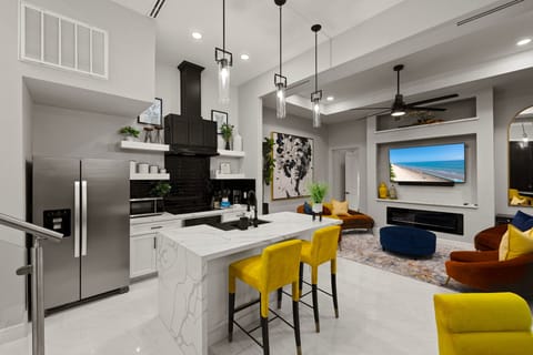 Fully equipped modern kitchen with spacious island seating, ideal for meals, entertaining, and gathering together.