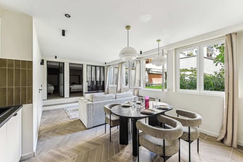 Salon confortable avec canapé convertible, TV et table à manger 