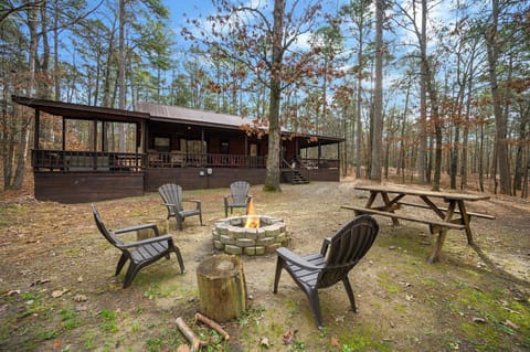 Relax outdoors with a firepit and picnic table among the trees