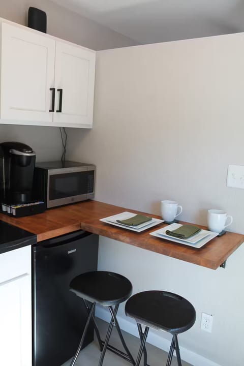 Fold away counter for prep space and meals plus a cabinet of dishes and utensils