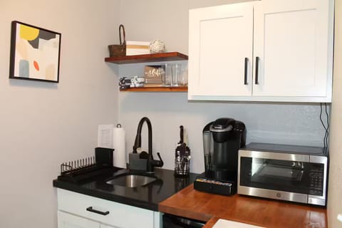 Kitchenette with Keurig and supplies, microwave, mini fridge and toaster.
