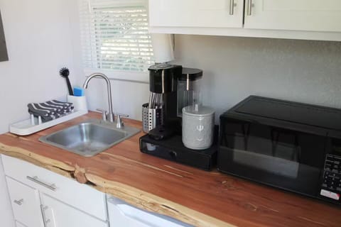 Kitchenette with microwave, mini fridge and coffee maker.