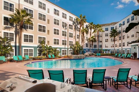 Dive into sunlit pool days with palm-lined loungers.