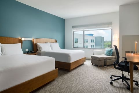 Relax in a spacious double-queen room with cozy seating.