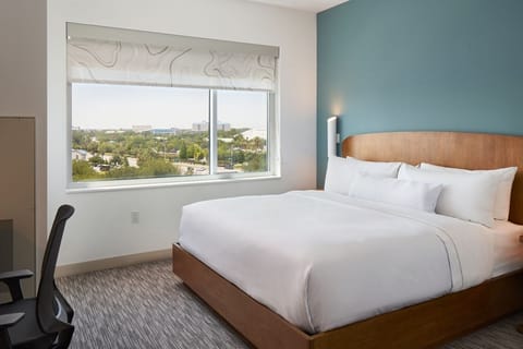 Unwind in a crisp king bed with bright city views.