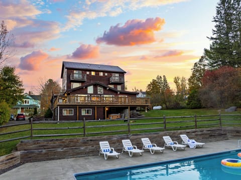 Enjoy the perfect poolside view with the beautiful home as your backdrop — relaxation meets style!