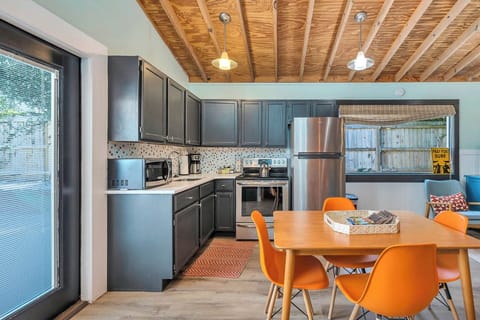 Guest House Kitchen and Dining Area – 530 Delegal - Guest house kitchen and dining area at 530 Delegal featuring a full kitchen, dining table, and direct access to the pool courtyard on St. Simons Island.