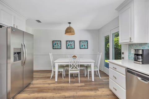 Main House Dining Area – 530 Delegal - Main house dining area at 530 Delegal showing a dining table and seating, with windows providing natural light.