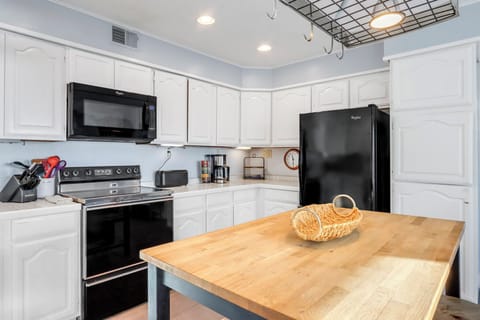 Modern appliances and a charming butcher block island, perfect for preparing memorable meals.
