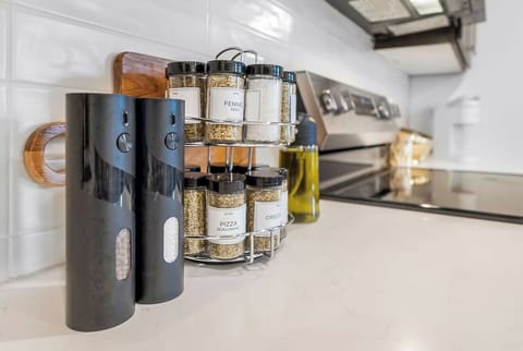 Discover your culinary creativity in this well-equipped kitchen with organized spices and modern appliances ready for your cooking adventures.