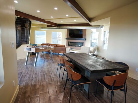 Your spacious game room invites friendly competition with foosball and plenty of seating, while the cozy fireplace creates the perfect backdrop for memorable evenings.
