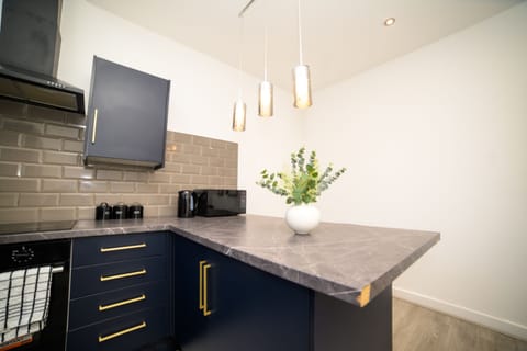 Well-appointed kitchen with essential appliances and ample workspace.