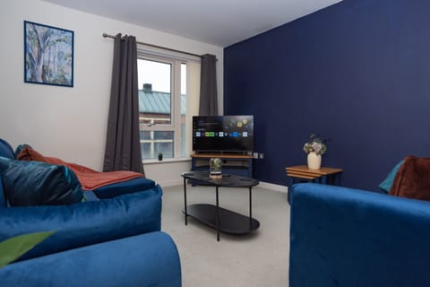 A comfortable living room with a smart TV and sofa bed, perfect for relaxing after work or a day of exploring