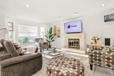 Spacious living room ideal for family time, with L-shaped sofa and large TV