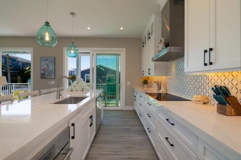 Step into your gourmet kitchen with gleaming white countertops, designer lighting, and everything you need to craft memorable meals during your stay.